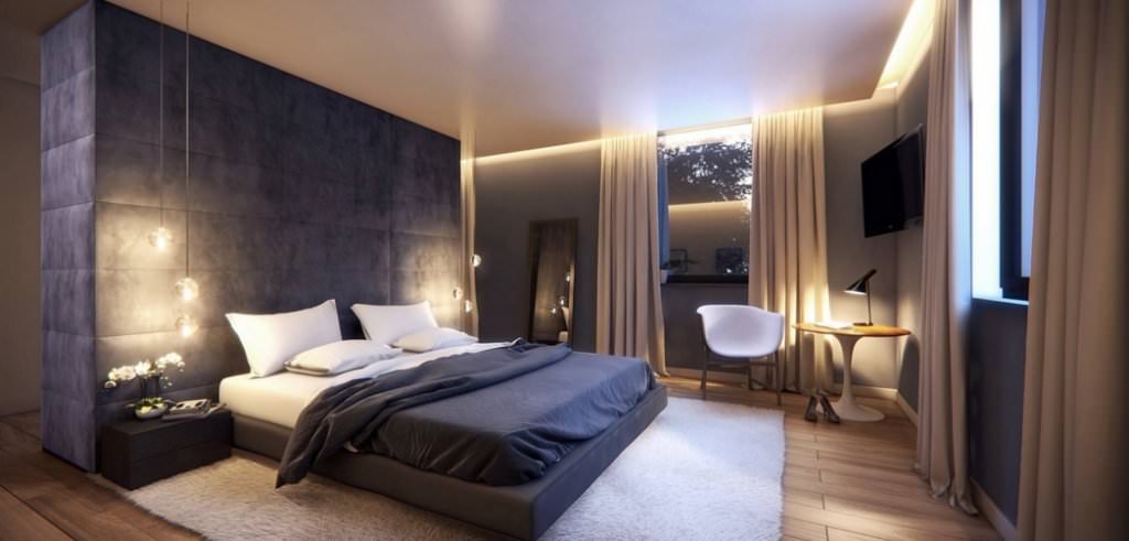 Camera da letto moderna in cui la luce è presente in ogni angolo - illuminazione perimetrale sul soffitto, lampade a sospensione sopra i comodini ed una lampada orientabile nel angolo lettura